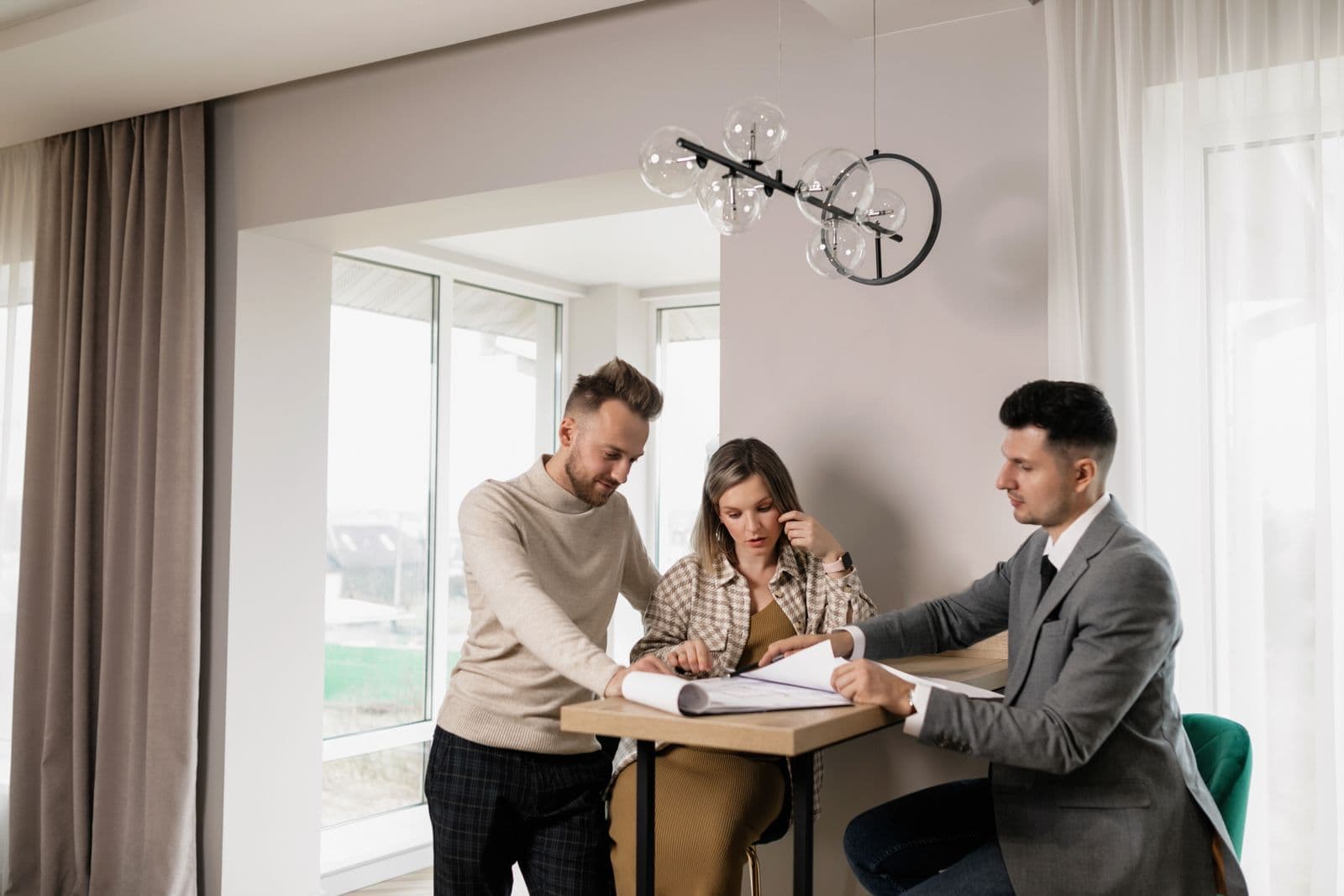 Real estate professionals reviewing brokerage records at a meeting