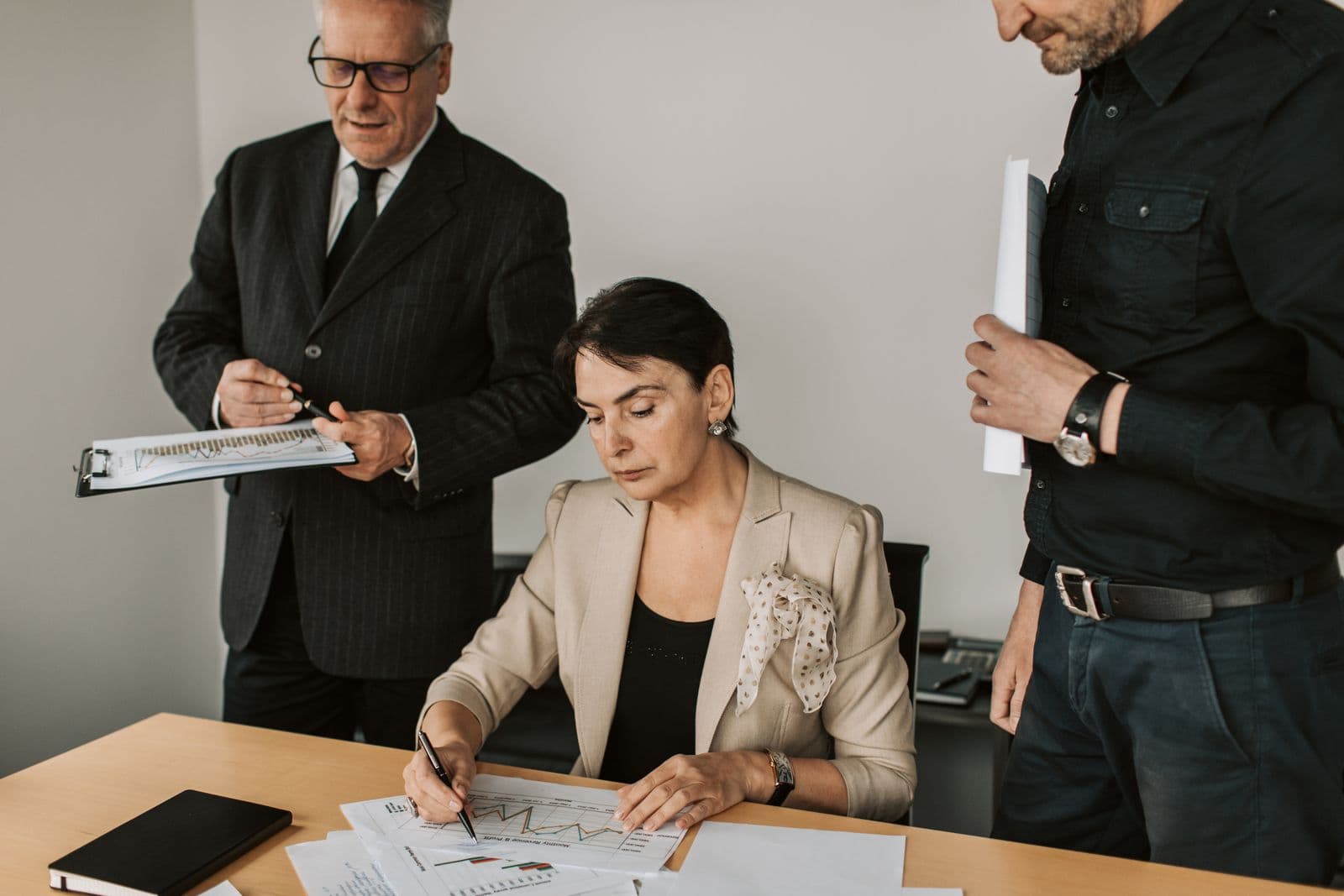 Business professionals reviewing corporate financial records