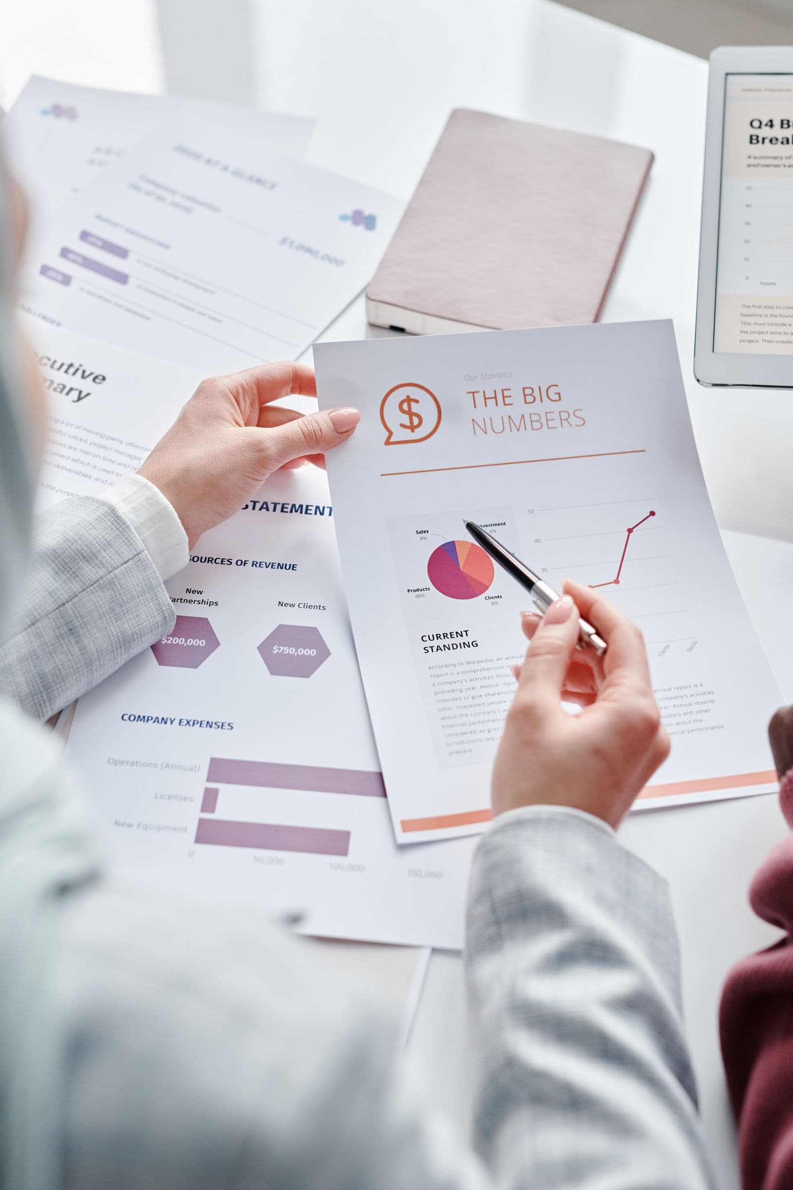 Corporate financial records and reports being reviewed at a business meeting